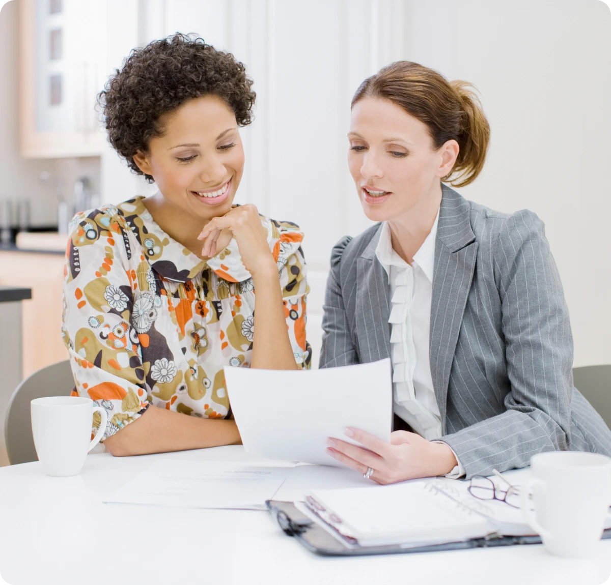 Colleagues discussing paperwork at table