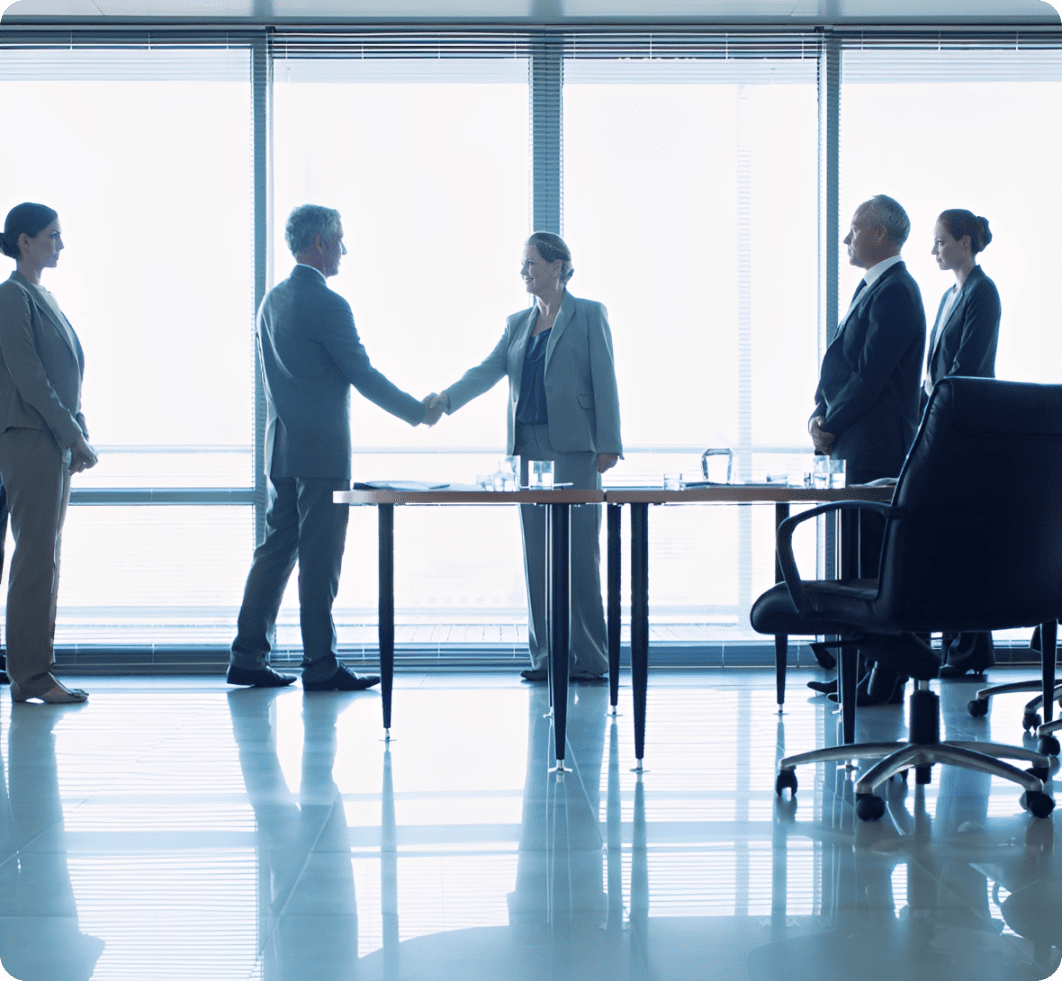Conference room handshake with colleagues