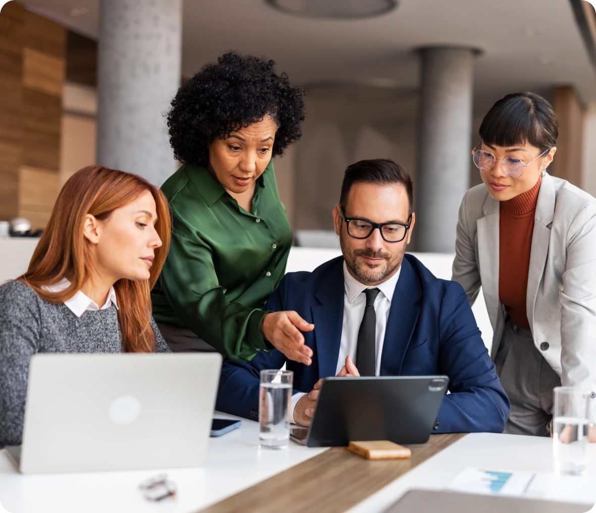 Team collaborating around a tablet